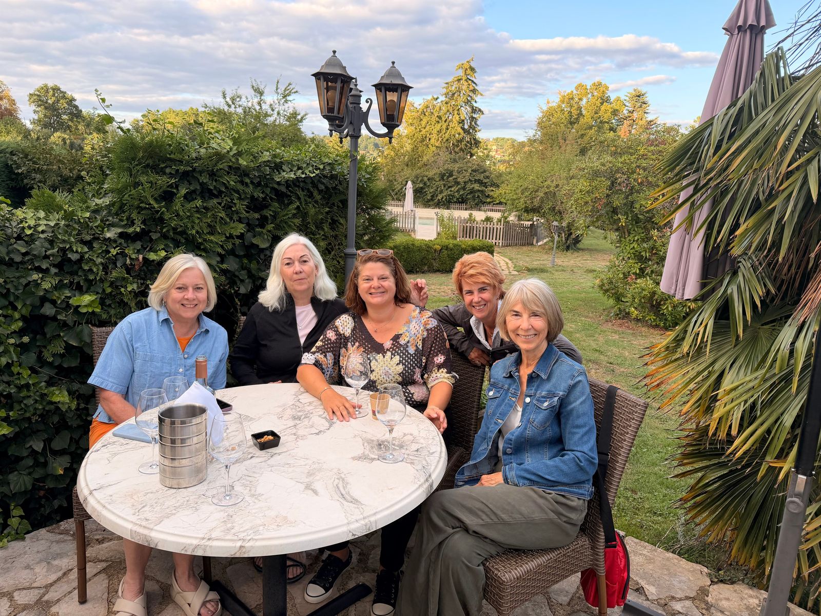 Cassie with a group of our guests around a garden table in Sarlat
