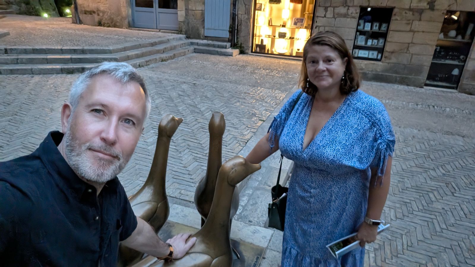 Kev and Cassie with the bronze goose statues on Place des Oies, Sarlat