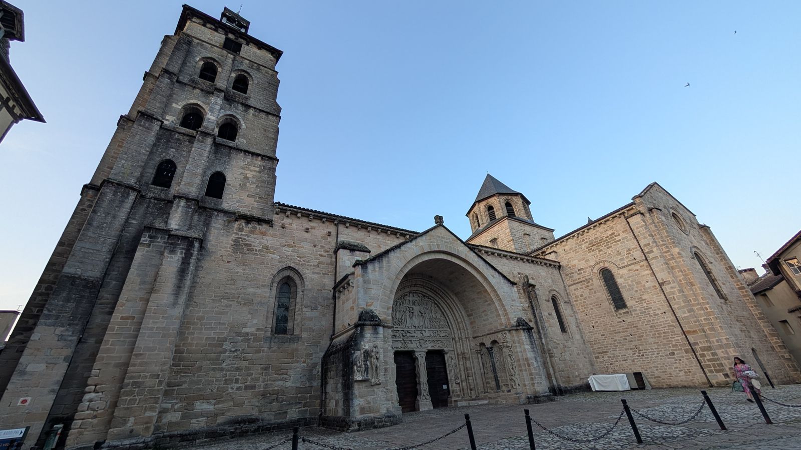 The Romanesque abbey church and bell tower on a square in Beaulieu-sur-Dordogne