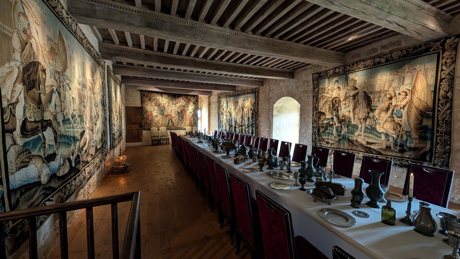 A banqueting hall hung with tapestries inside the Château de Beynac