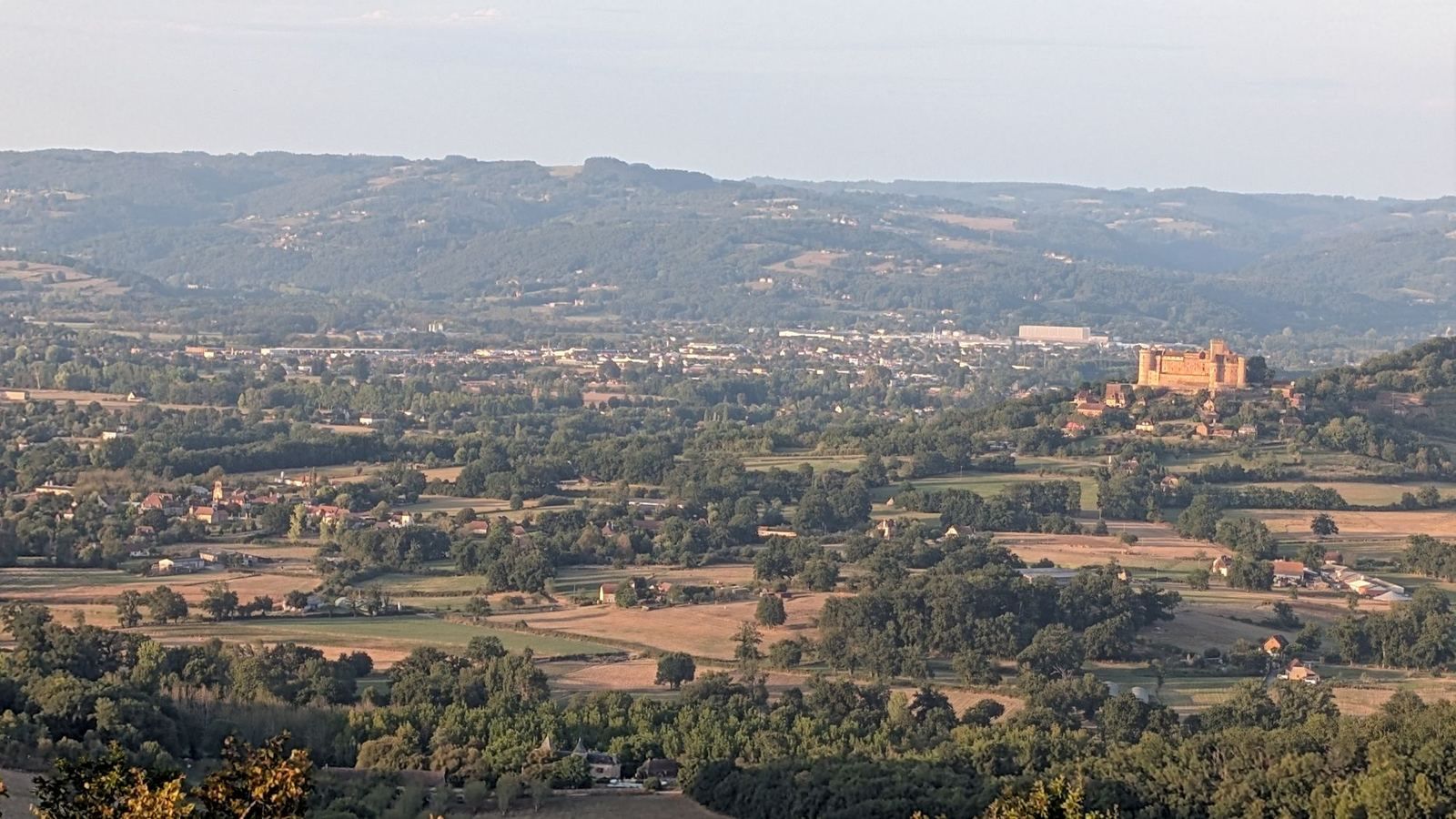 The red Château de Castelnau across the valley