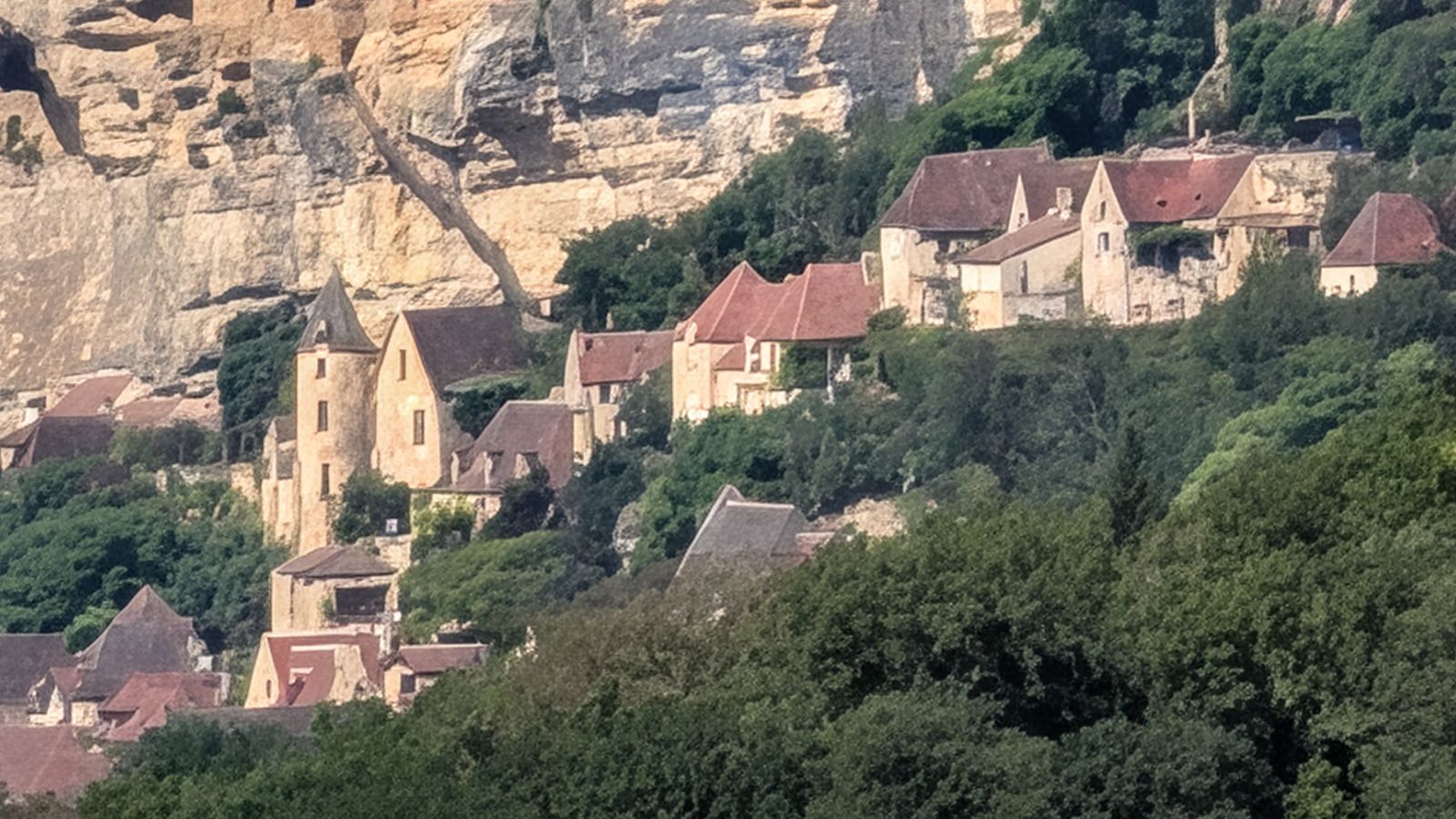 La Roque-Gageac's golden houses tucked beneath its cliff