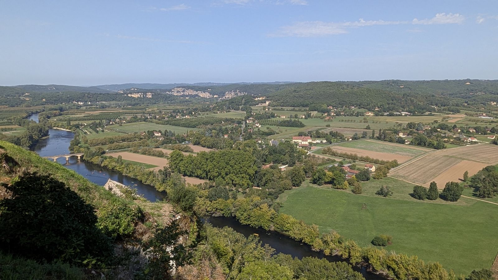 Fields and the winding Dordogne far below the clifftop at Domme