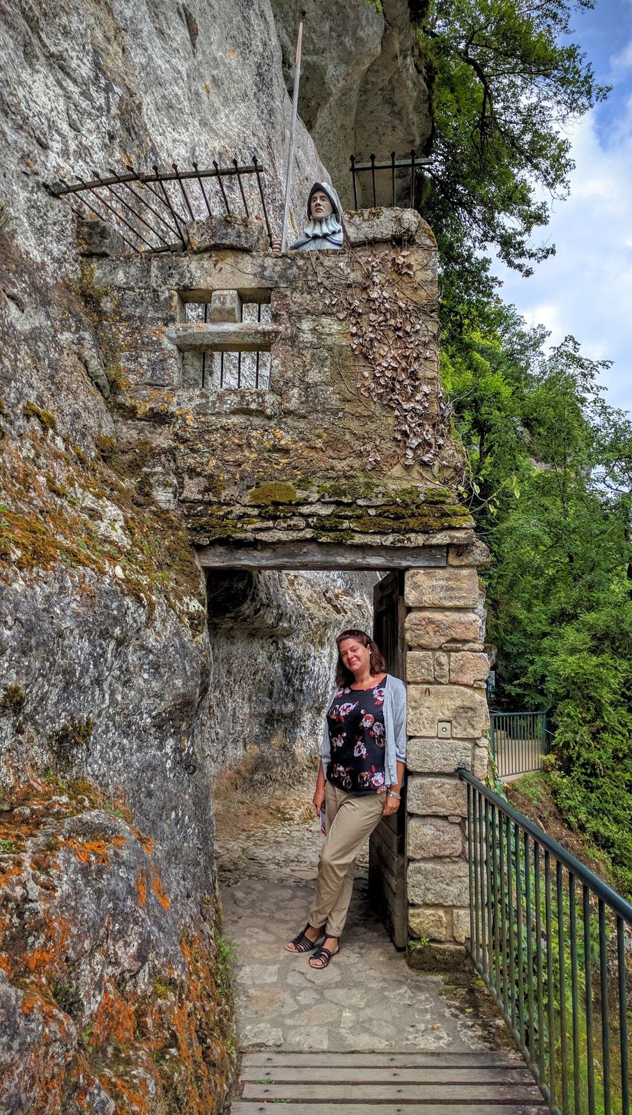 Cassie at a stone gateway on the cliff terraces of La Roque Saint-Christophe
