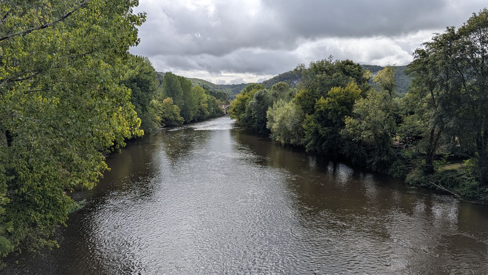 The Vézère flowing between wooded banks at Les Eyzies