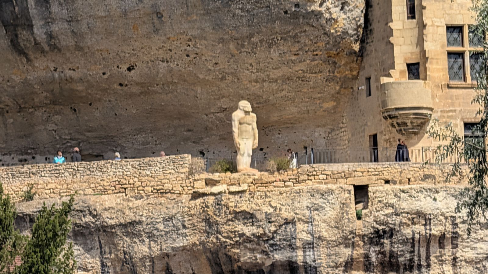 The statue of early man on the cliff terrace of the National Museum of Prehistory, Les Eyzies