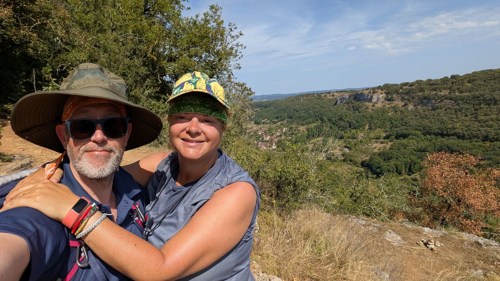 Kev and Cassie, hats on, above the valley