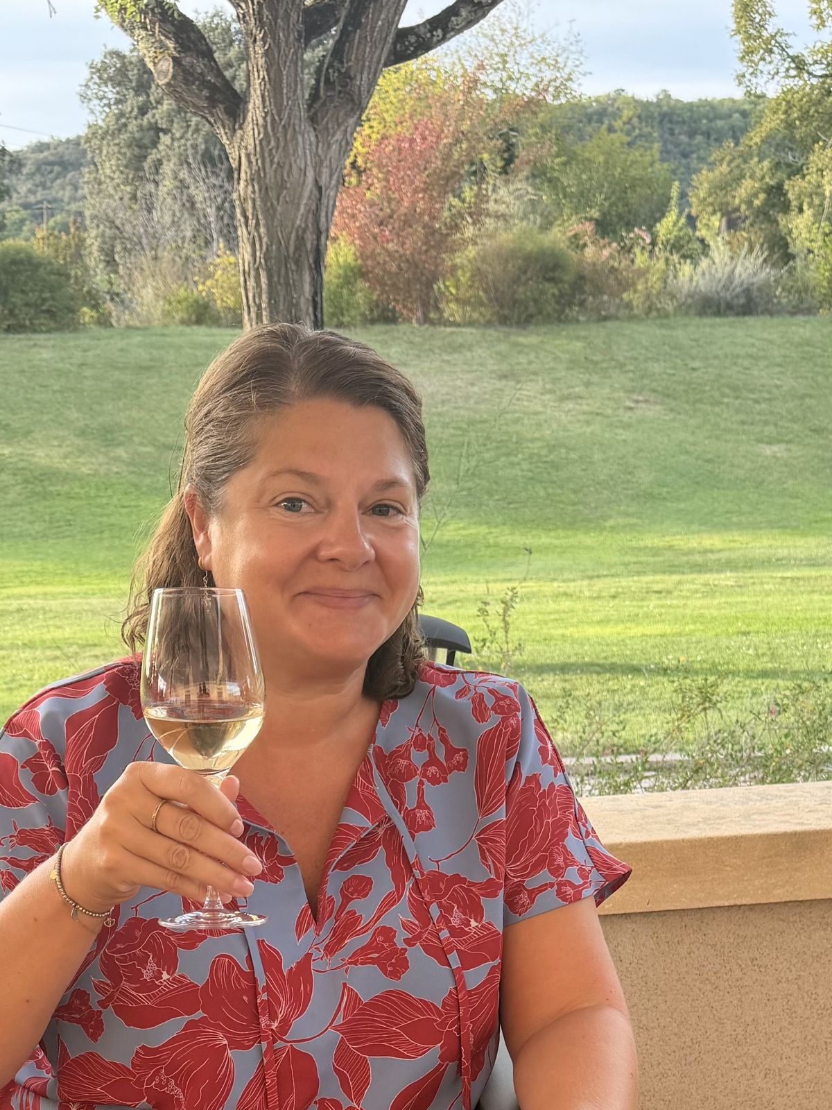 Cassie with a glass of wine at Le Port de Domme