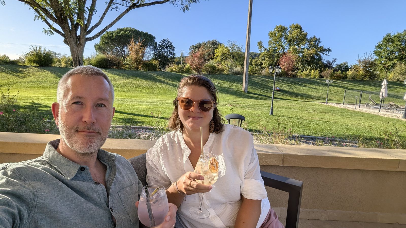 Kev and Cassie with drinks on the terrace at Hôtel Le Périgord