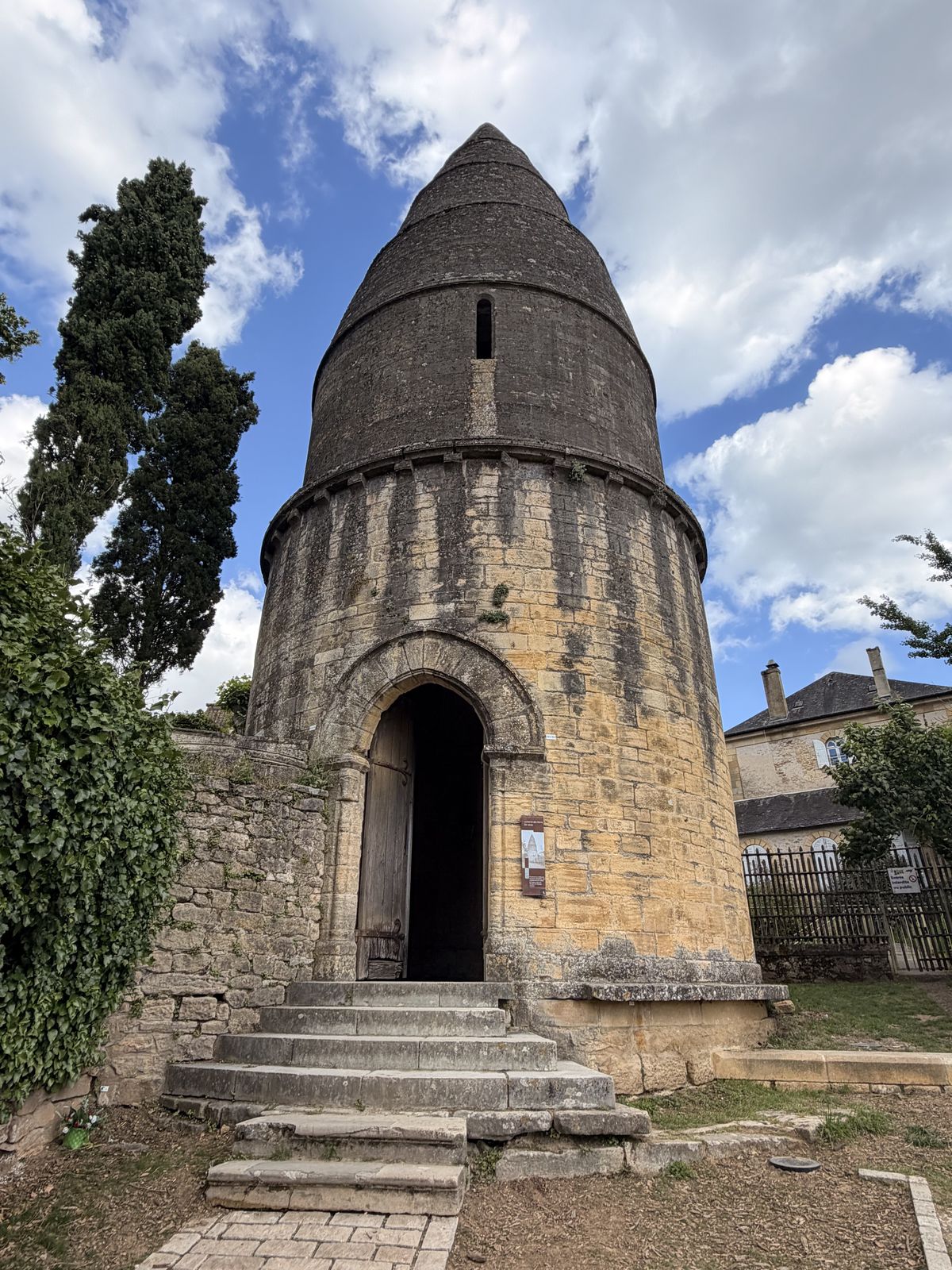 A round stone tower with a conical stone roof, the Lantern of the Dead in Sarlat