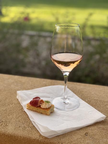 A glass of rosé and a canapé on the terrace at Hôtel Le Périgord