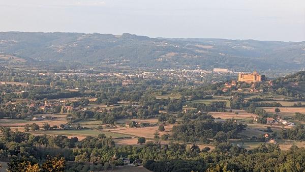 The red Château de Castelnau across the valley